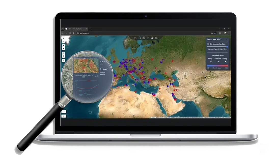 A laptop screen displaying the LaGrand web application map, showing industrial activity across Europe, the Middle East, and North Africa. A magnifying glass zooms in on a single steel plant in Germany, providing detailed decomposed activity data based on thermal analysis.