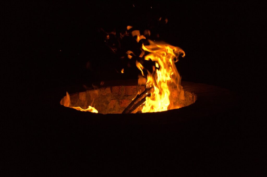 A fire pit lit up in the dark