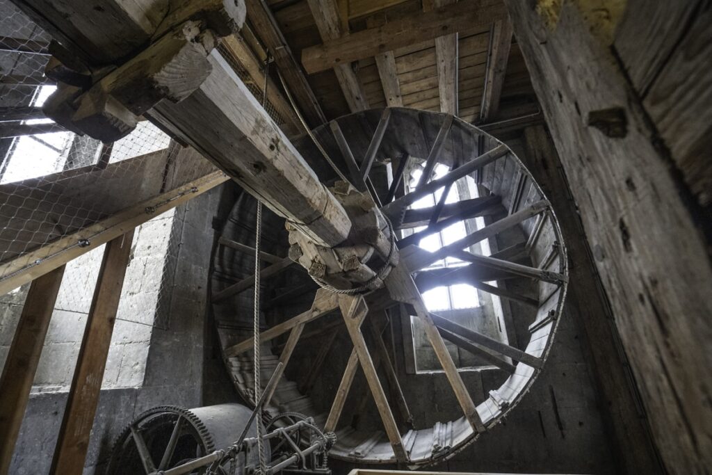 A large metal wheel inside of a building