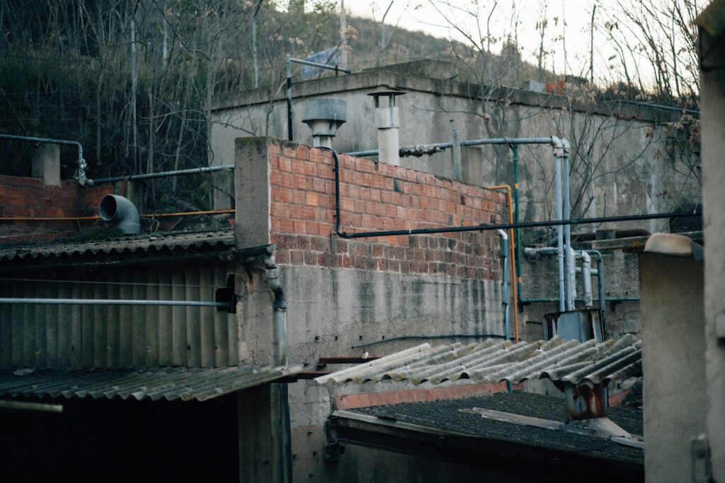 a brick building with pipes and pipes on top of it