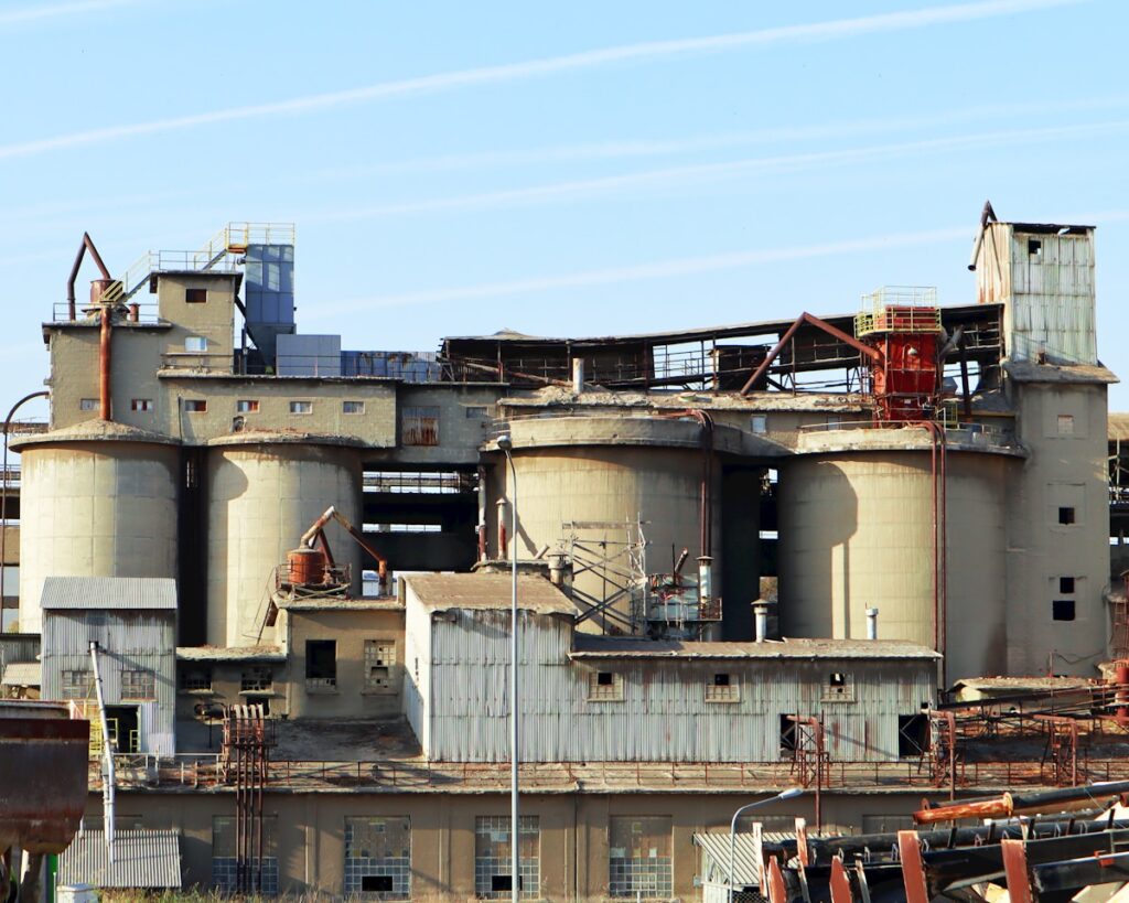 A large industrial building with lots of rust on it