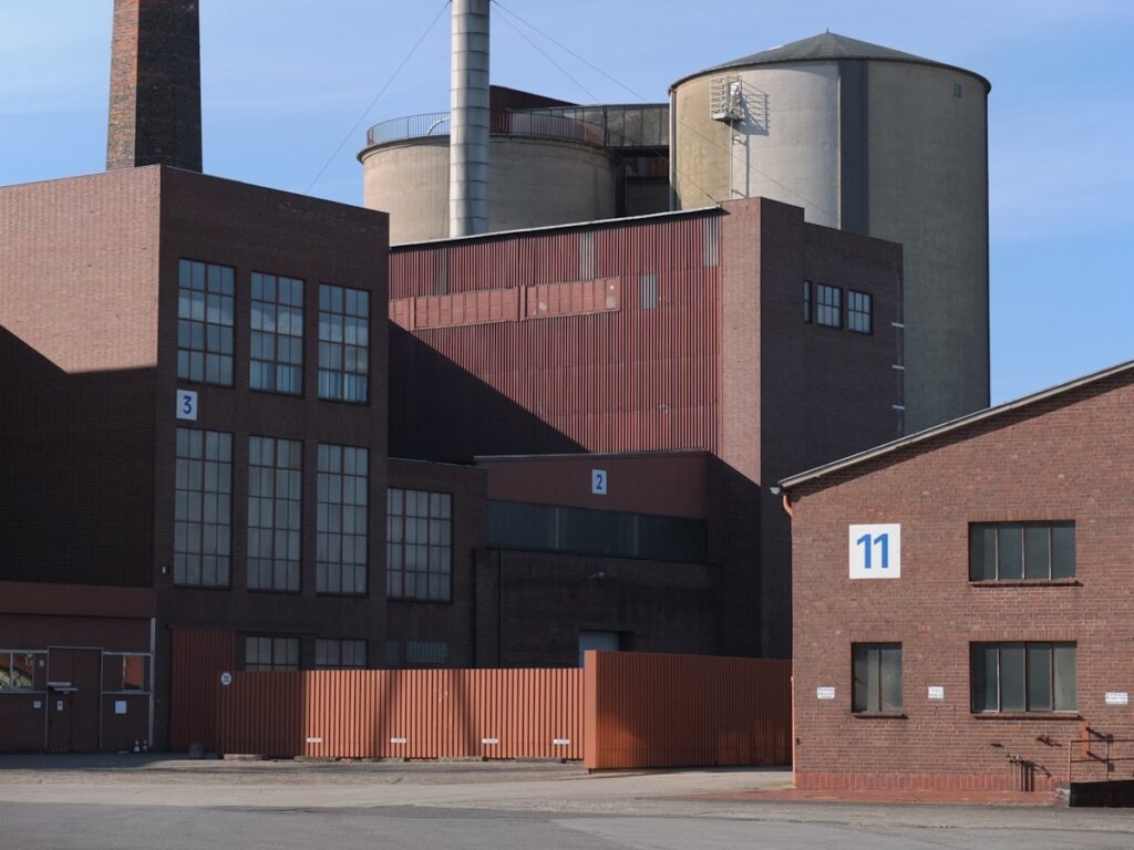 a building with a lot of windows next to a parking lot