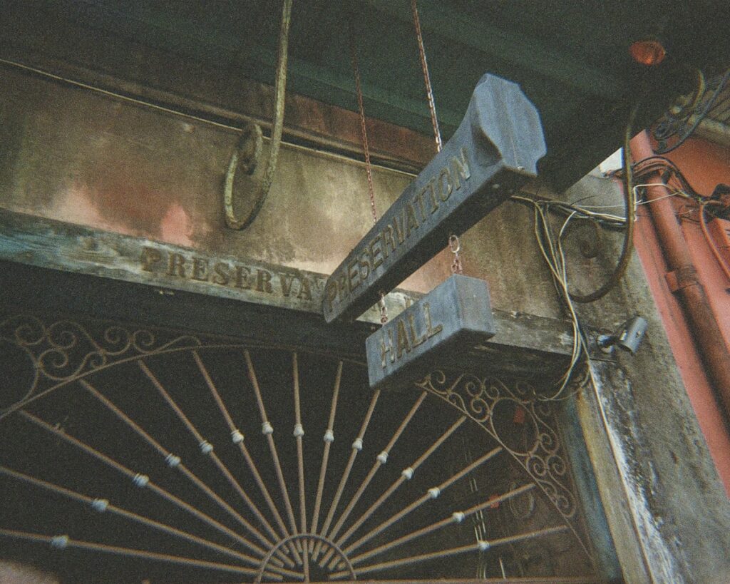 An old sign hangs above an ornate door.