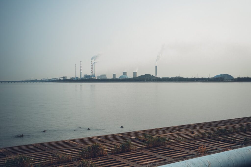 Industrial complex with smokestacks by the water