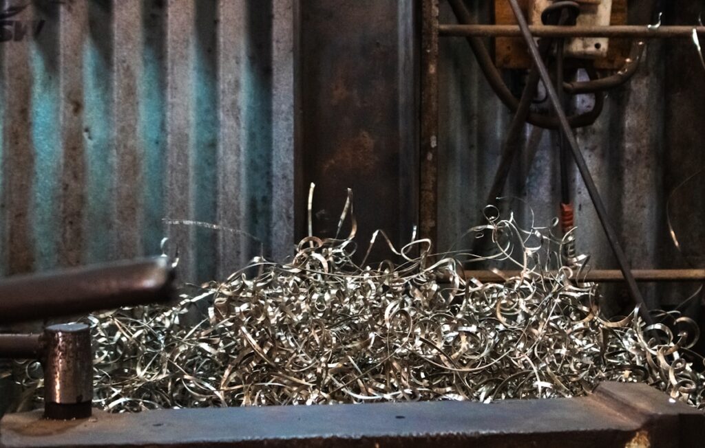 Metal shavings pile up on a workbench.