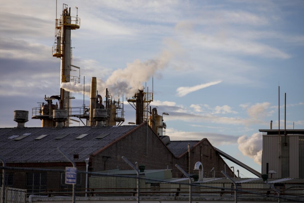 a factory with smoke coming out of it's stacks